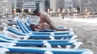 Amateur couple unashamedly fuck on a beach sunlounge