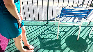 Pee in her dress on the open balcony
