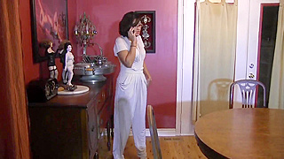 Tied up brunette is teased by a busty blonde with a great cleavage